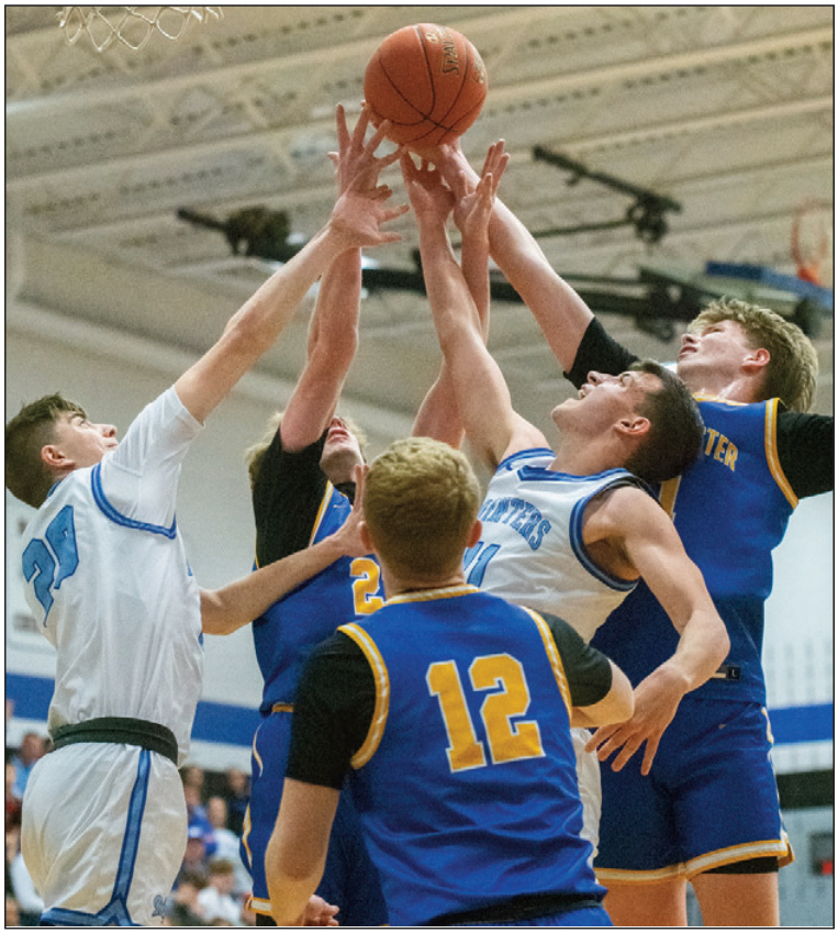 It's battle for a rebound with Hudson Schroeder (20), Drew Aschliman (11) and three Lancaster players. Photo by Robin Wiegman.