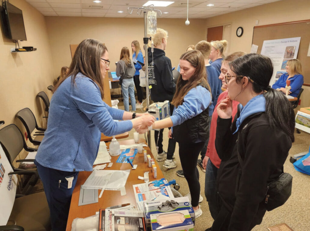 Devon Wamsley - Acute Care Charge Nurse talks with students.