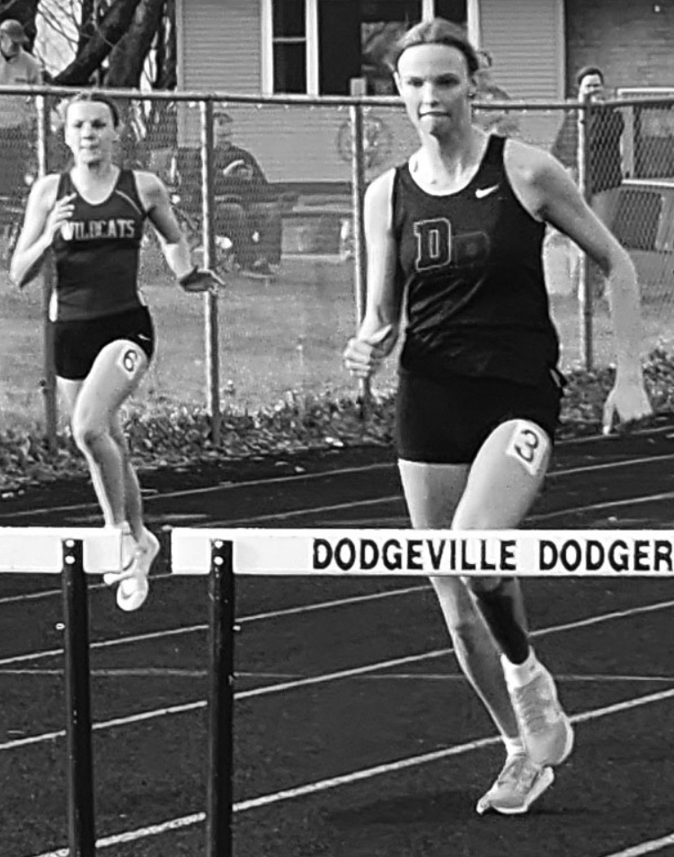 Kit Finley looks to clear a hurdle. Photo by Amy Robinson.