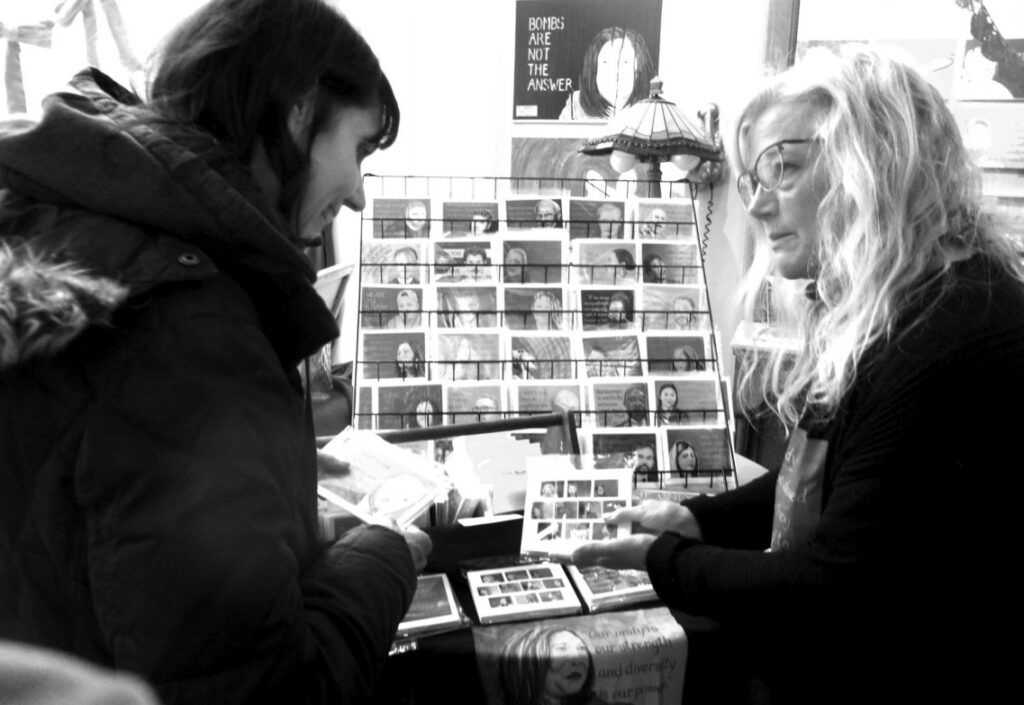 Helen Avakian consults with Kate Olsen Birner, whose Courage show opened on Gallery Night Saturday at Proper Maid. The exhibit includes portraits, cards and prints of people whose courage inspired the artist. It runs through April 25. Gallery Nights continue on June 6, Aug. 1 and Dec. 5, which coincides with Candlelight Shopping.