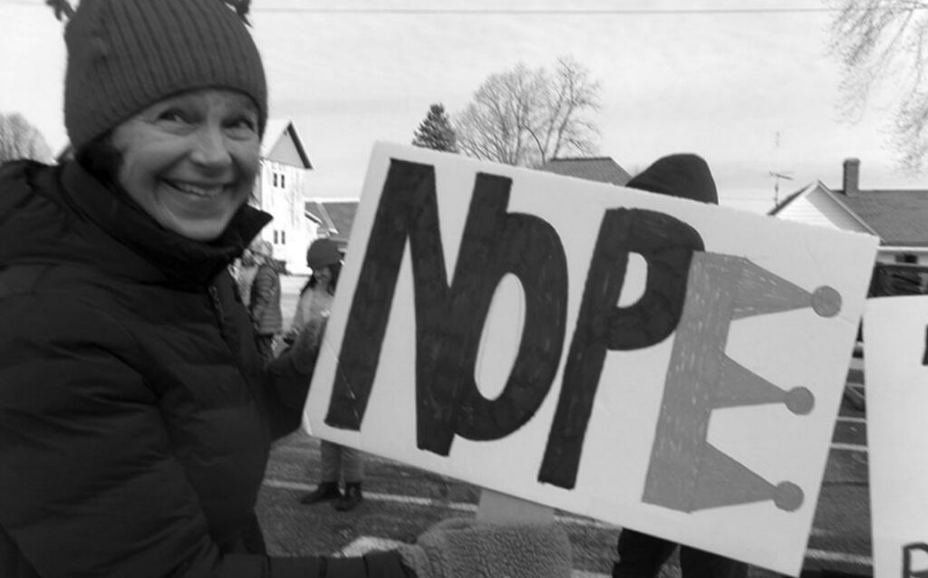 Michelle Bensen of Mineral Point chose a sign to carry in the No Kings March Saturday in Dodgeville.