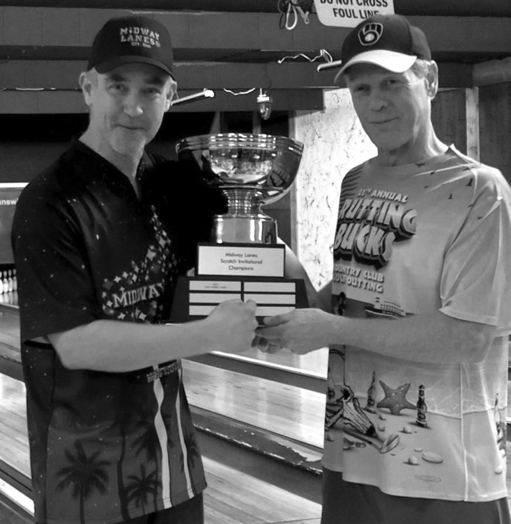 Last years Invitational champion Gary 'Horse' James (right) presents this years trophy to champion Kevin Gallagher who won this years scratch event.