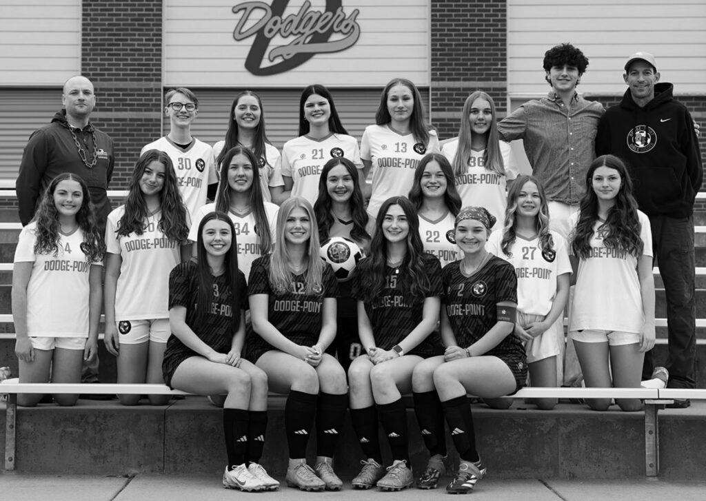 Members of the 2026 Dodge-Point United girls soccer team are (l-r) front: Seniors - Emma Giddings, Layla Novak, Aly Jones, and Ella Wilson; middle: Cat Biddick, Lily Fox, Lilly Houtakker, Lucy Paynter, Abilene Bartz, Mya Marklein, and Jessie Solberg; back: Head Coach Andy Weber, Jo Anderson, Mallory Allen, Sidney Stefkovich, Sara Moyle, Sophia Marr, Manager Massimo Robinson, and Assistant Coach Ryan Fox. Not pictured is Kendallyn Juno.