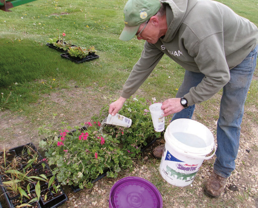 Mike Robinson watering flowers