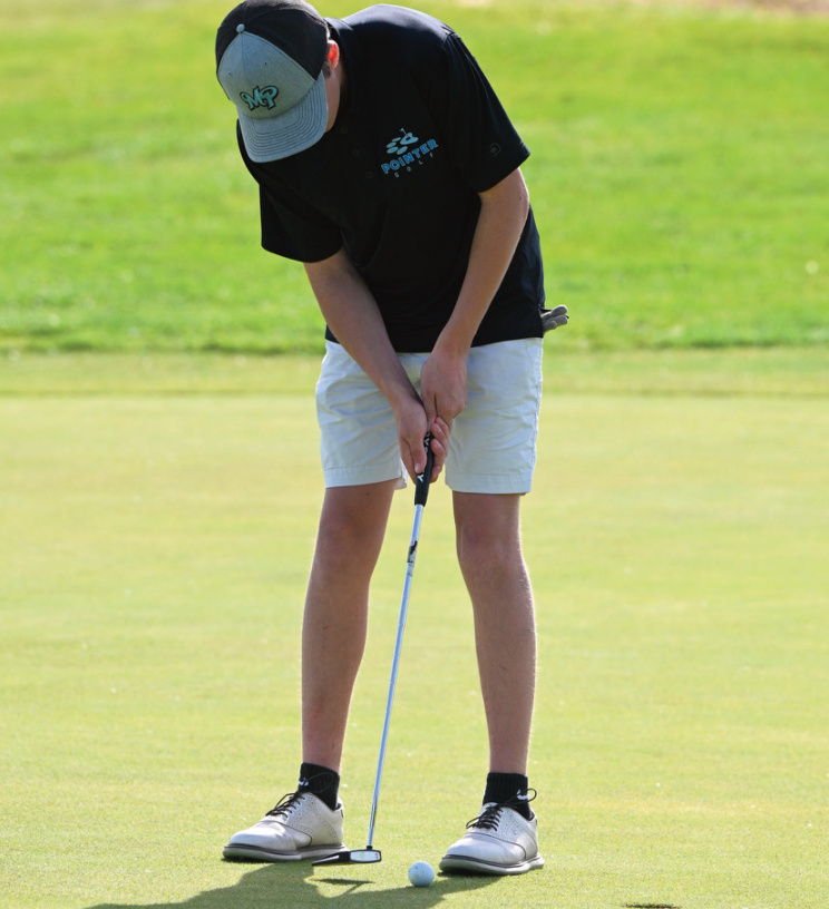 Gaige Godfrey taps in a short putt. Photo by Anita Schmid.