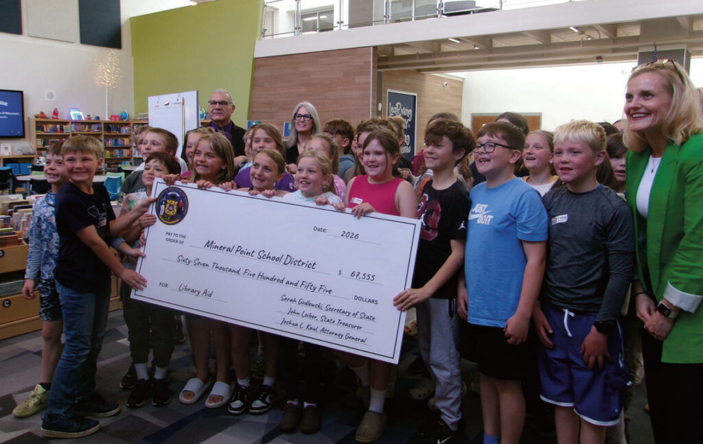 Mineral Point third and fourth graders pose with a check for library aid delivered by Secretary of State Sarah Godlewski last Thursday.