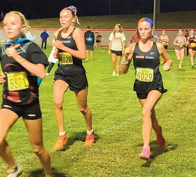 Abby Finley (6020) and Autumn Pagenkopf (6029) try to move up. Photo by Amy Robinson.