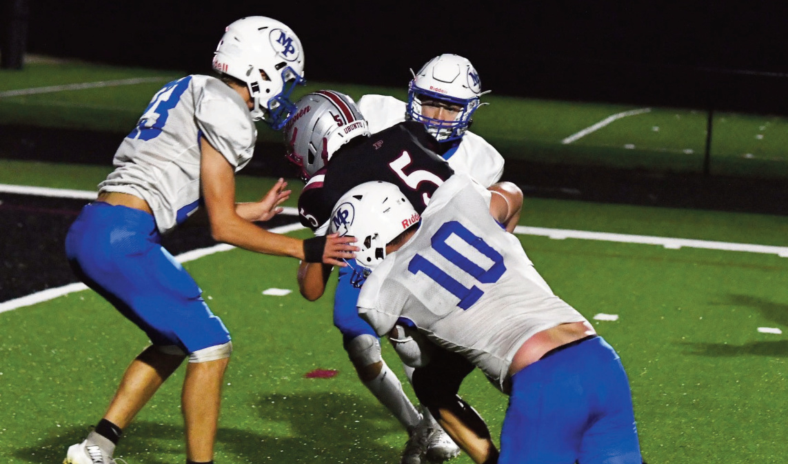Clayton Yanna makes a stop on a Hillmen running back with Cowan Bishell (23) moving in to help out. Photo by Jason Nihles.