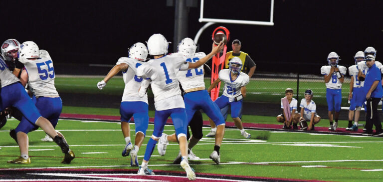 Quarterback Liam Carey looks to throw to Elliot Kite (21) behind blocking by Emmett Collins (72) and Sawyer Dannenberg (55). Photo by Jason Nihles.