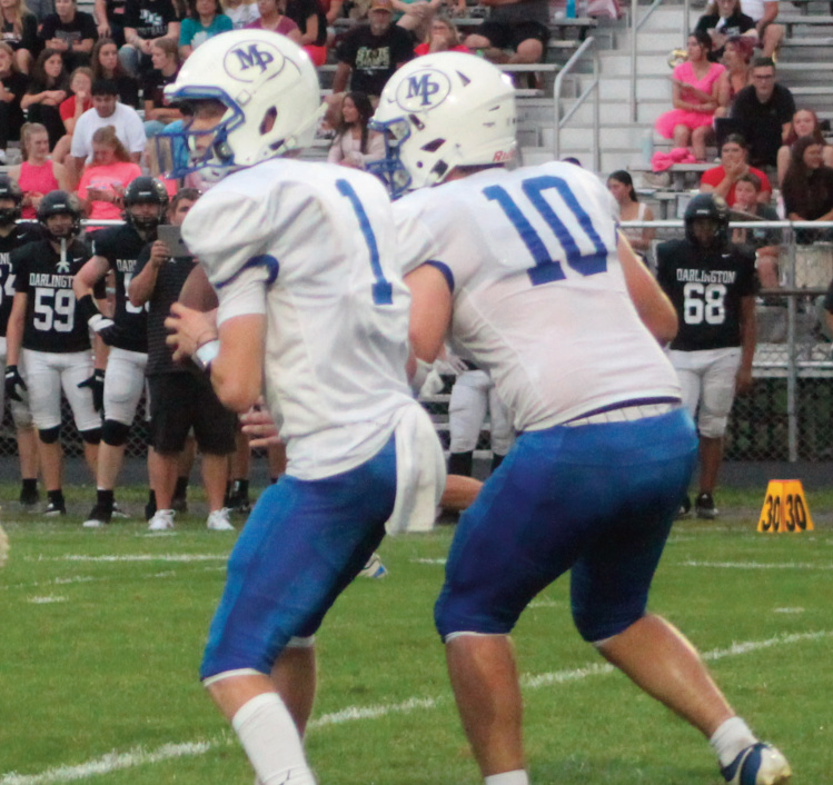 Liam Carey looks to pass with Clayton Yanna blocking.