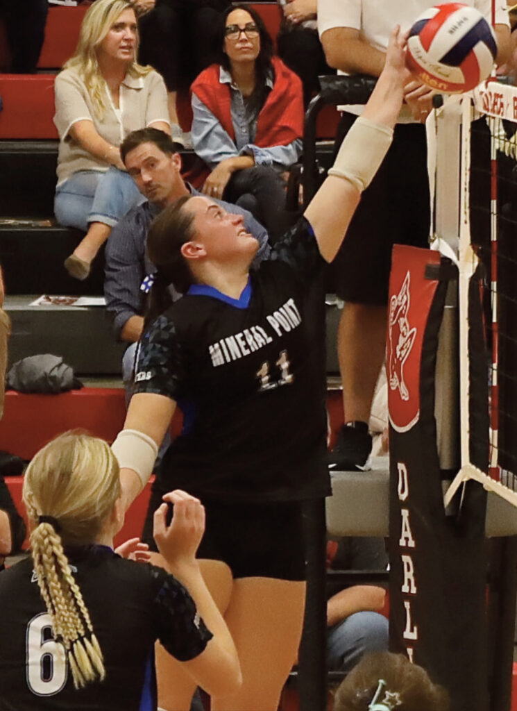 Brynn Swenson puts a shot over the net with Kinlee Prust (6) looking on. Photo byTori Carey.